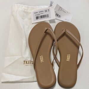 New never worn TKEES flip flops in brown.